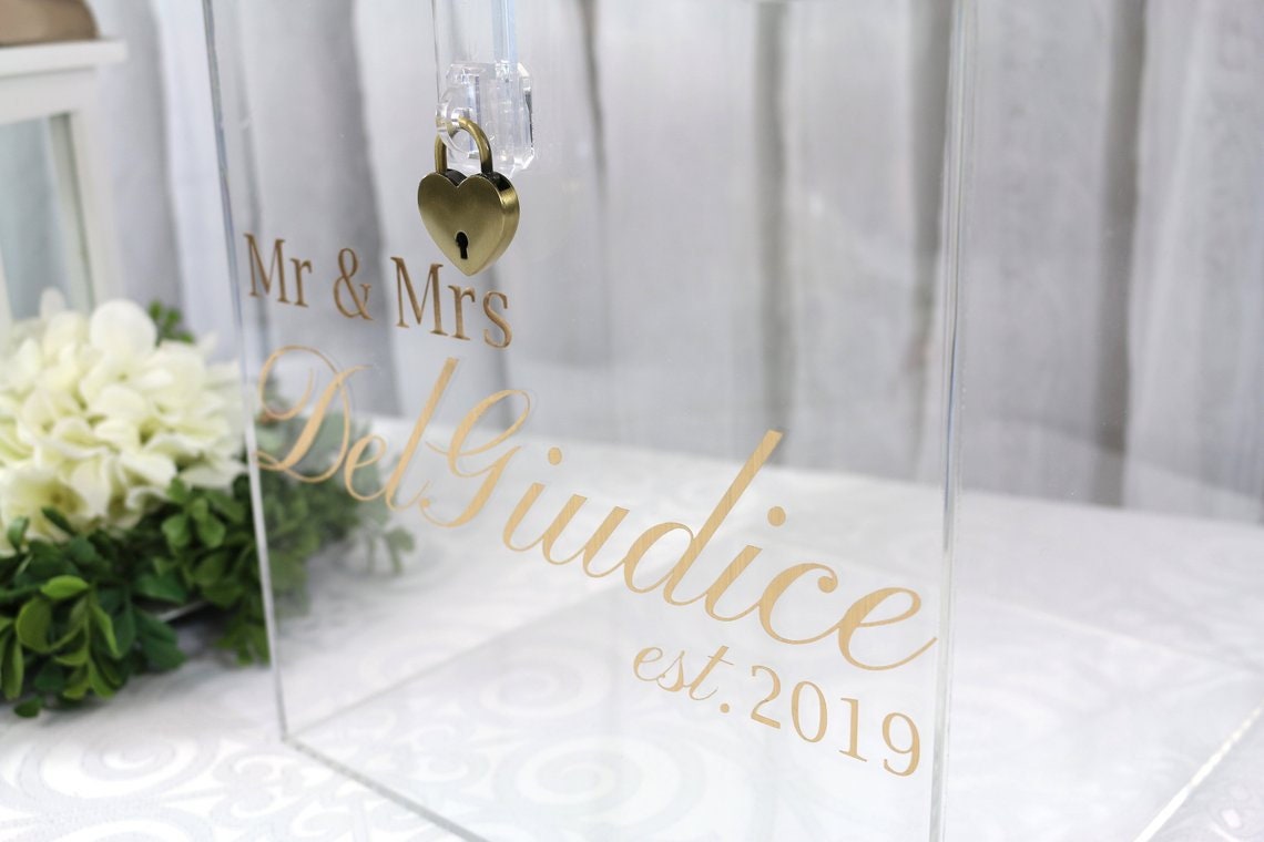 Acrylic card box with lock and key. Customizable designs and fonts made to keep celebratory cards, money or event donations safe and accessible. Place this beautiful card box anywhere your guests gather. thequinnandcompany www.thequinnandcompany.com