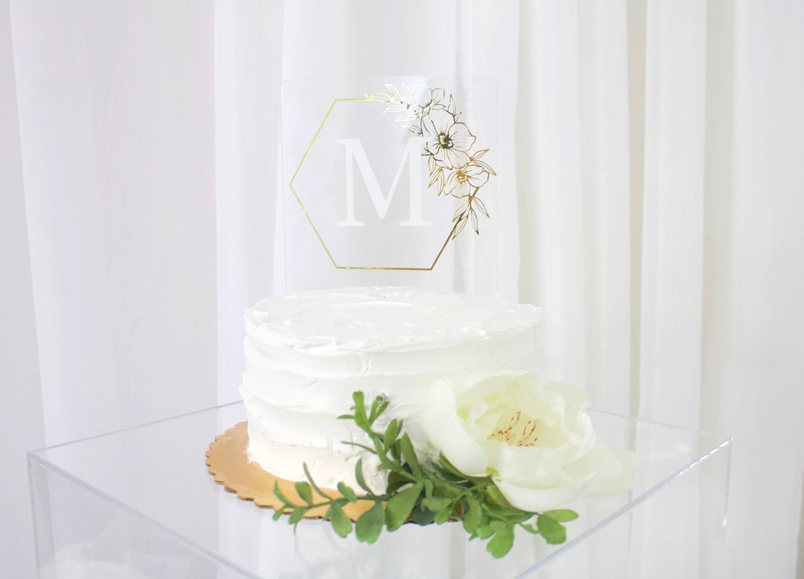Wedding cake topper. Wooden or acrylic cake topper customized for any of your celebratory needs. Simplistic and elegant designs paired with multiple color schemes to top your celebratory baked goods. thequinnandcompany. www.thequinnandcompany.com