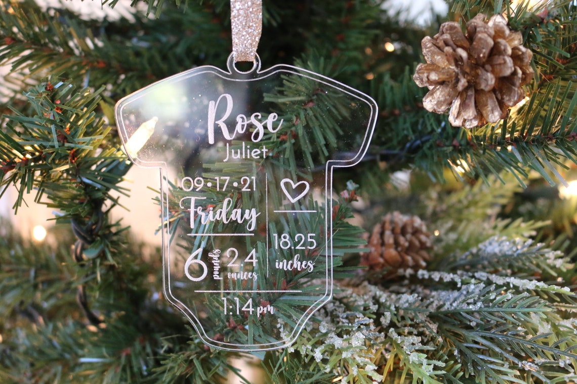 Personalized Baby Christmas Ornament. Made from acrylic, this ornament is the perfect decoration to celebrate the precious addition to your family. Laser cut lettering with multiple ribbon options. thequinnandcompany. www.thequinnandcompany.com