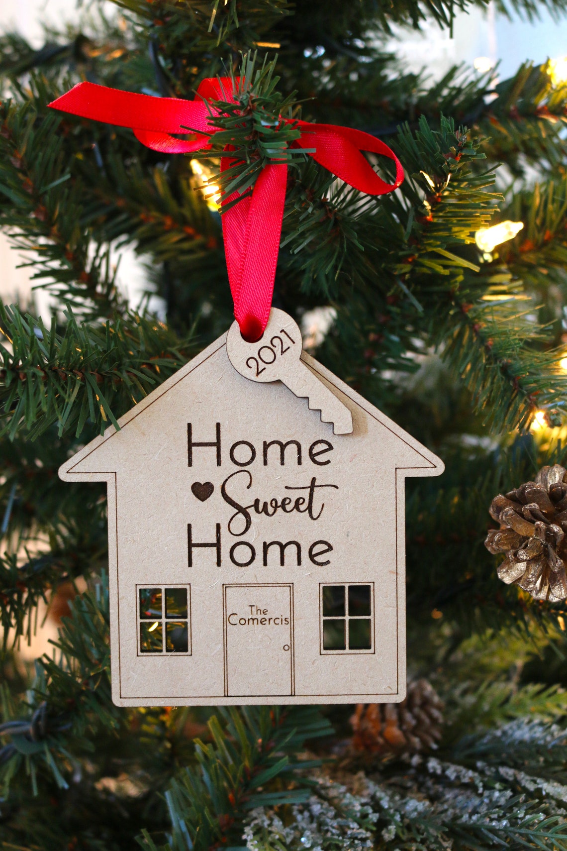 Personalized Acrylic Christmas Ornament. Made from acrylic or wood, this ornament is the perfect decoration to celebrate life’s most memorable moments. Ornaments arrive in a kraft gift box embellished with a black bow Customer design laser cut lettering with multiple ribbon options. thequinnandcompany. www.thequinnandcompany.com