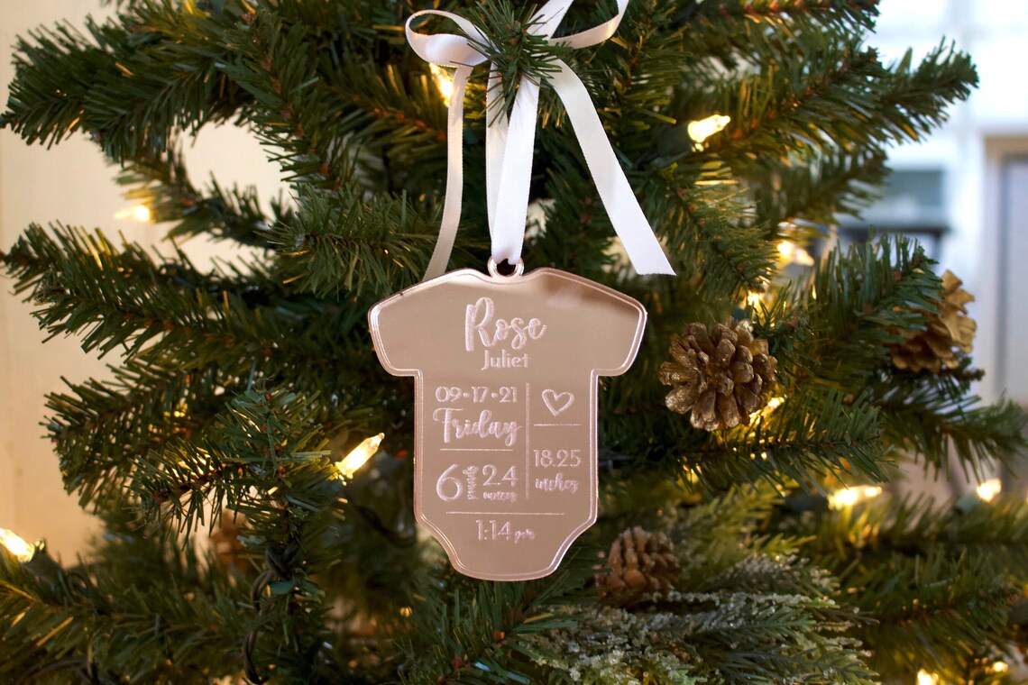 Personalized Baby Christmas Ornament. Made from acrylic, this ornament is the perfect decoration to celebrate the precious addition to your family. Laser cut lettering with multiple ribbon options. thequinnandcompany. www.thequinnandcompany.com