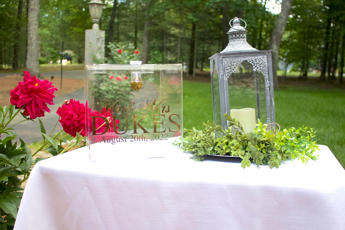 Acrylic card box with lock and key. Customizable designs and fonts made to keep celebratory cards, money or event donations safe and accessible. Place this beautiful card box anywhere your guests gather. thequinnandcompany www.thequinnandcompany.com