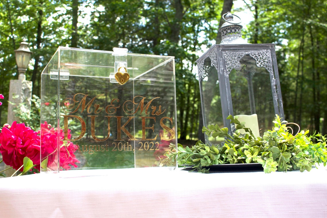 Acrylic card box with lock and key. Customizable designs and fonts made to keep celebratory cards, money or event donations safe and accessible. Place this beautiful card box anywhere your guests gather. thequinnandcompany www.thequinnandcompany.com