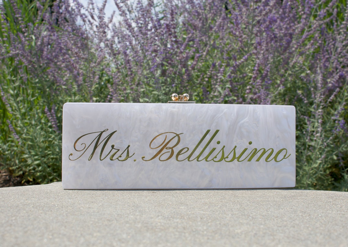 Acrylic clutch. Customizable and personalized for your wedding day. Elegant design with stylish lettering. Durable acrylic and hardware makes this clutch a necessity to carry your necessities. thequinnandcompany. www.thequinnandcompany.com