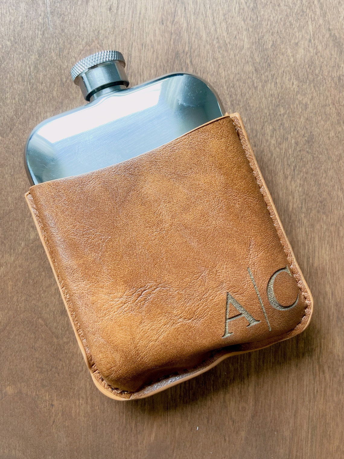 Flask set. A lovely gift for birthdays, Father's Day, or for the groomsmen at your wedding. Fill the flask with their favorite drink for a thoughtful surprise. Each personalized men's flask is custom laser engraved to your specifications and is made of stainless steel.