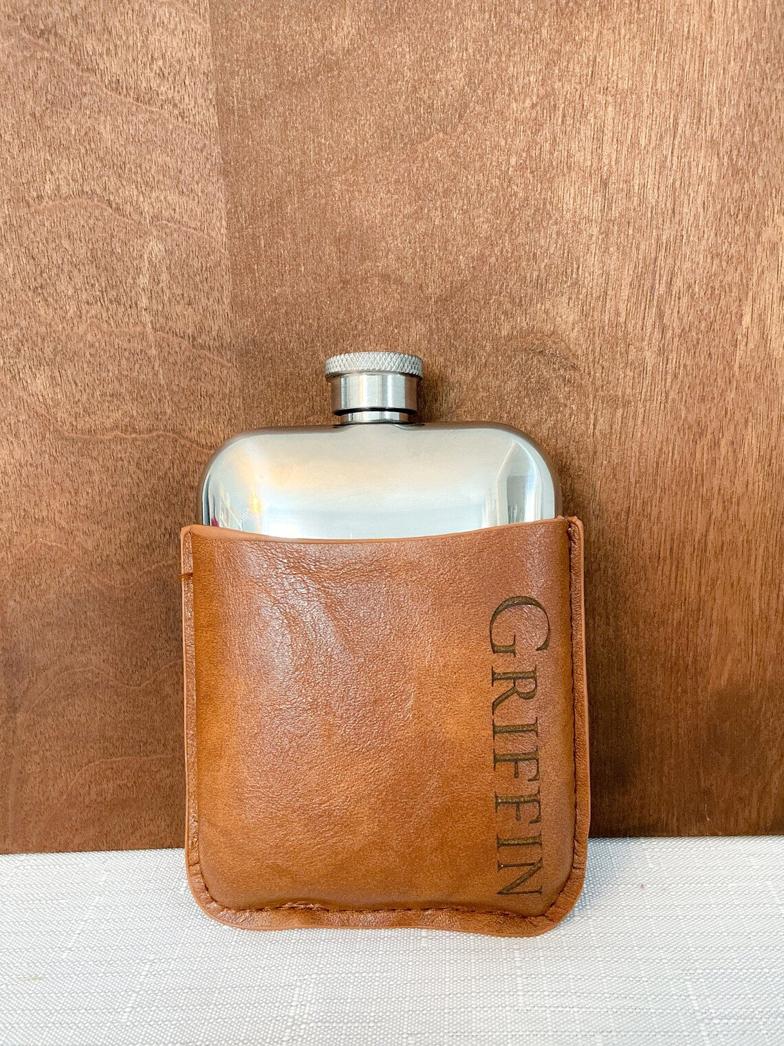 Flask set. A lovely gift for birthdays, Father's Day, or for the groomsmen at your wedding. Fill the flask with their favorite drink for a thoughtful surprise. Each personalized men's flask is custom laser engraved to your specifications and is made of stainless steel.