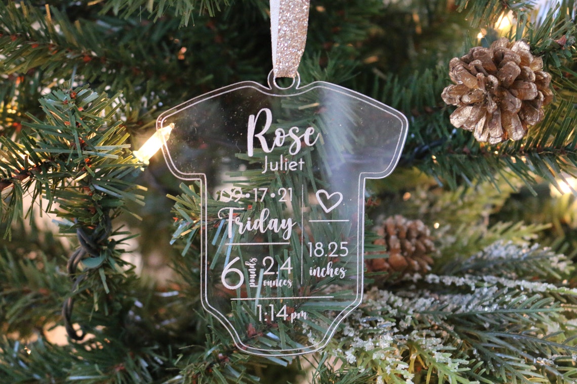 Personalized Baby Christmas Ornament. Made from acrylic, this ornament is the perfect decoration to celebrate the precious addition to your family. Laser cut lettering with multiple ribbon options. thequinnandcompany. www.thequinnandcompany.com